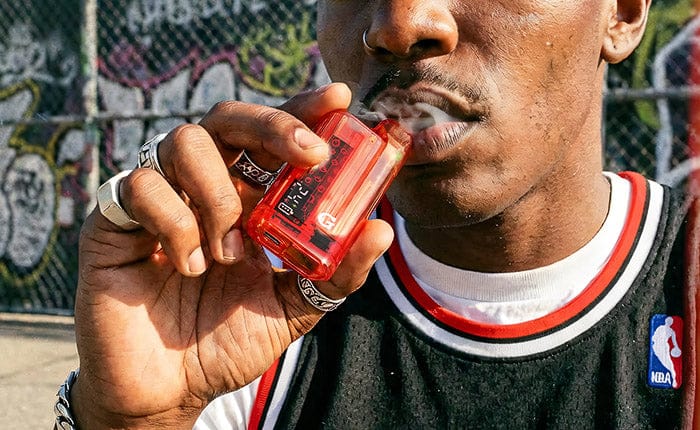 Red Translucent G Pen Hydout held to the lips