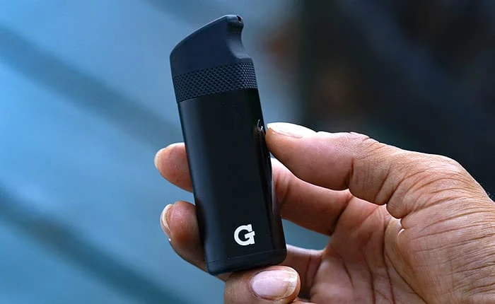 Hand holding the G Pen Micro II concentrate vaporizer with the G logo